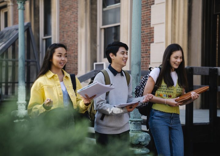Photo of a Man and His Friends Talking while Walking
